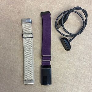 Fitbit Charge 6 with charger and cream strap